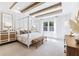 Serene bedroom with a four-poster bed, exposed wood beams, and plenty of natural light at 357 Claret Cup Way, Charleston, SC 29414