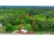 Aerial view of home surrounded by lush trees, showcasing its peaceful and private setting at 358 Highway 78, Ridgeville, SC 29472