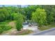 Aerial view of home with two-car garage surrounded by mature trees and lush greenery at 358 Highway 78, Ridgeville, SC 29472