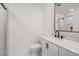 Bathroom featuring a modern vanity with black hardware, a gold framed mirror, and a marble shower at 358 Highway 78, Ridgeville, SC 29472