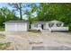Exterior view of white home with two-car garage and welcoming front porch at 358 Highway 78, Ridgeville, SC 29472