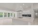 Bright kitchen featuring white cabinets, a modern island, and access to a lounge at 358 Highway 78, Ridgeville, SC 29472