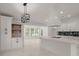 Bright kitchen featuring white cabinets, a modern island, and stylish lighting at 358 Highway 78, Ridgeville, SC 29472