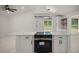 Kitchen island with black range set in white quartz top with white cabinets and black fittings at 358 Highway 78, Ridgeville, SC 29472