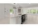 Kitchen island with black range set in white quartz top with white cabinets and black fittings at 358 Highway 78, Ridgeville, SC 29472