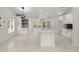Bright kitchen featuring white cabinets, a modern island, and marble floors at 358 Highway 78, Ridgeville, SC 29472