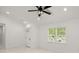 Bright living room with white walls, modern ceiling fan, and plenty of natural light at 358 Highway 78, Ridgeville, SC 29472