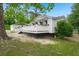 Exterior side view of white home with well-maintained landscaping and a two-car garage at 358 Highway 78, Ridgeville, SC 29472