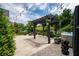 The backyard has a hot tub, beautiful vegetation, a pergola with patio furniture and a grill at 3656 Spindrift Dr, Mount Pleasant, SC 29466