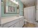 Bathroom with white cabinets, a decorative mirror, and a shower with white curtains at 3656 Spindrift Dr, Mount Pleasant, SC 29466
