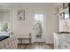 Bright bedroom featuring a door to the outdoor seating area with a wicker chair and bench at 3656 Spindrift Dr, Mount Pleasant, SC 29466