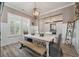 Bright dining room showcasing natural light, modern lighting, and seamless flow to office at 3656 Spindrift Dr, Mount Pleasant, SC 29466