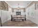 Formal dining room features wainscoting, modern chandelier, and a neutral color palette at 3656 Spindrift Dr, Mount Pleasant, SC 29466
