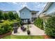 A beautifully landscaped backyard and a blue house with a quaint second story balcony at 3656 Spindrift Dr, Mount Pleasant, SC 29466