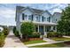 Charming light blue two-story home with a covered porch and well-manicured landscaping at 3656 Spindrift Dr, Mount Pleasant, SC 29466