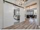Open-concept living room with stylish sliding doors, hardwood floors, and cozy seating at 3656 Spindrift Dr, Mount Pleasant, SC 29466