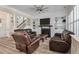 Inviting living room with built-in shelving, a fireplace, and comfortable leather seating at 3656 Spindrift Dr, Mount Pleasant, SC 29466