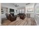 Bright living room with hardwood floors and fireplace flows into adjacent dining area at 3656 Spindrift Dr, Mount Pleasant, SC 29466
