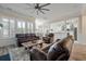 Open living room with hardwood floors and leather furniture, bathed in natural light at 3656 Spindrift Dr, Mount Pleasant, SC 29466