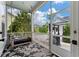 Relaxing screened porch features comfortable seating, stylish rug, and scenic backyard view at 3656 Spindrift Dr, Mount Pleasant, SC 29466