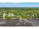 Lush green canopy from an aerial view of waterfront homes, each featuring private docks reaching into the river at 3948 Gift Blvd, Johns Island, SC 29455