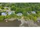 Aerial shot of waterfront homes nestled in lush greenery, each with private docks extending into the river at 3948 Gift Blvd, Johns Island, SC 29455