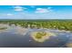 Aerial view of a waterfront property with a private dock, an island, and a tranquil river and sky at 3948 Gift Blvd, Johns Island, SC 29455