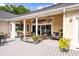 Relaxing covered porch with outdoor furniture, decorative plants, and seamless transition to the indoors at 3948 Gift Blvd, Johns Island, SC 29455