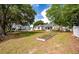 Spacious backyard featuring an adjacent garden, lush trees, and a waterfront at 3948 Gift Blvd, Johns Island, SC 29455
