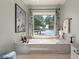 A luxurious bathtub set against a backdrop of scenic lake views and decorative accents offers a serene bathing experience at 3948 Gift Blvd, Johns Island, SC 29455