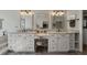 Stylish bathroom featuring double vanity, marble countertops, framed mirrors, and modern lighting fixtures at 3948 Gift Blvd, Johns Island, SC 29455