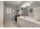 Bright bathroom featuring blue walls, white cabinets, and a large mirror at 3948 Gift Blvd, Johns Island, SC 29455