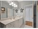 Bright bathroom featuring gray walls, white cabinets, and neutral accents at 3948 Gift Blvd, Johns Island, SC 29455
