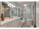 Bright bathroom featuring a white vanity, ample lighting, and a decorative mirror that enhances the space at 3948 Gift Blvd, Johns Island, SC 29455