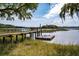 Picturesque waterfront view with a private wooden dock featuring a seating area and floating platform at 3948 Gift Blvd, Johns Island, SC 29455
