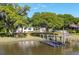 Waterfront home with mature trees, dock, and floating dock providing access to the water at 3948 Gift Blvd, Johns Island, SC 29455