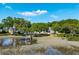 Waterfront home featuring lush trees, a private dock, and scenic views of the marshland at 3948 Gift Blvd, Johns Island, SC 29455