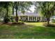 Traditional-style home surrounded by mature trees and lush landscaping at 3948 Gift Blvd, Johns Island, SC 29455