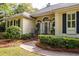 Charming home entrance with arched windows, black shutters, and manicured landscaping at 3948 Gift Blvd, Johns Island, SC 29455
