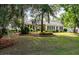 Charming home featuring lush landscaping, mature trees, and a well-manicured lawn at 3948 Gift Blvd, Johns Island, SC 29455