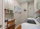 Well-organized laundry room featuring modern washer and dryer, built-in shelving, and a convenient folding rack at 3948 Gift Blvd, Johns Island, SC 29455