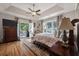Inviting main bedroom with waterfront views, hardwood floors, tray ceiling, and access to a private patio at 3948 Gift Blvd, Johns Island, SC 29455
