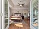 Bright main bedroom featuring a full ensuite bathroom, wood floors, and French doors at 3948 Gift Blvd, Johns Island, SC 29455
