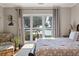 Main bedroom with scenic water view, tray ceiling, hardwood floors, stylish decor, and natural light at 3948 Gift Blvd, Johns Island, SC 29455