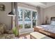 Bright main bedroom with waterfront views, tray ceiling, hardwood floors, stylish decor, and cozy sitting area at 3948 Gift Blvd, Johns Island, SC 29455