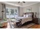 Beautiful main bedroom with waterfront views and tray ceiling, hardwood floors, and natural light at 3948 Gift Blvd, Johns Island, SC 29455
