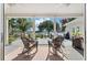 Covered patio with rocking chairs offering water views, creating a relaxing outdoor space at 3948 Gift Blvd, Johns Island, SC 29455