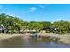 Scenic waterfront property with mature trees, a private dock, and a tranquil pond at 3948 Gift Blvd, Johns Island, SC 29455
