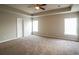 Spacious bedroom features plush carpet, tray ceiling with fan, and ample natural light from two windows at 4021 Sanderson Ln, Summerville, SC 29483