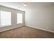 Bedroom with neutral walls, carpet, and two windows providing natural light at 4021 Sanderson Ln, Summerville, SC 29483